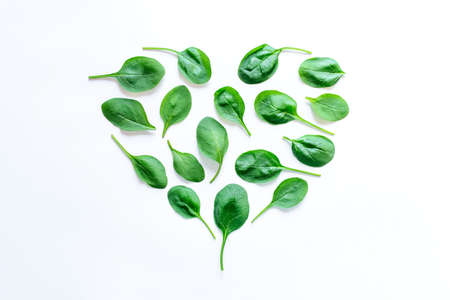 Beautiful pattern of fresh spinach leaves on white background. Flat lay.の写真素材