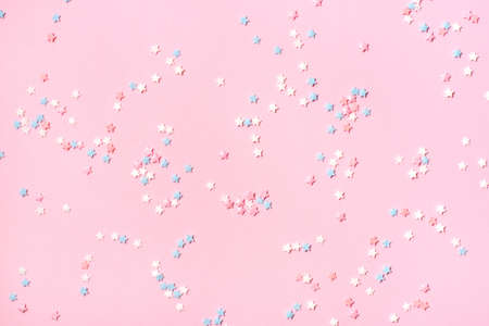 Confetti in the form of small stars on a pink background. Holiday concept.の写真素材