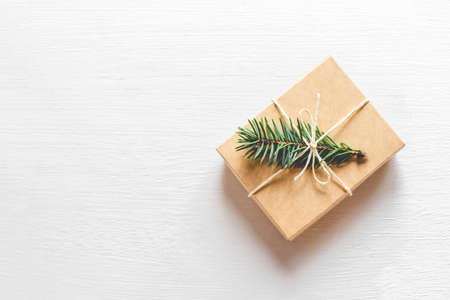 Christmas gift with fir branch on white background. Flat lay, top view. Copy space foryour text.の写真素材