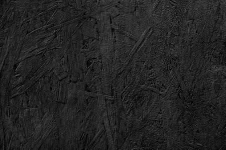 The texture of the wood particle board painted black color.
