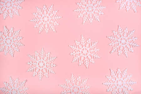 Winter pattern made of snowflakes and on pink background. Christmas concept. Flat lay.の写真素材