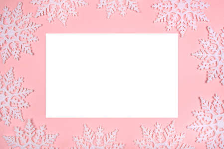 Winter pattern made of snowflakes and on pink background. Christmas concept. Flat lay. Copy space for your text.の写真素材