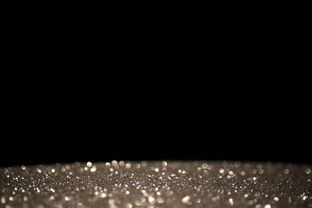 Abstract silver bokeh on black background. Holiday conceptの写真素材
