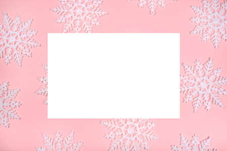 Winter pattern made of snowflakes and on pink background. Christmas concept. Flat lay. Copy space for your text.の写真素材