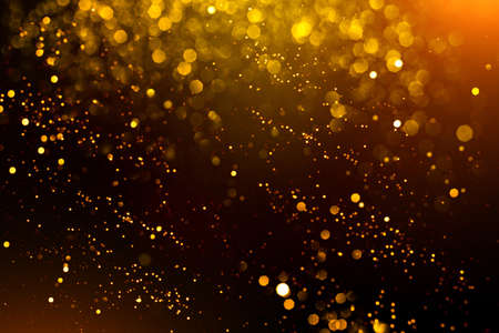 Golden abstract bokeh on black background. Holiday conceptの写真素材