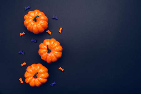 Halloween holiday background with pumpkins and bats. Flat lay, top view. Copy space for your text.の写真素材