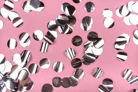 Silver confetti on pink background. Flat lay, top view.の写真素材