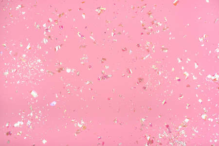 Pearl confetti on pink background. Flat lay, top view.の写真素材