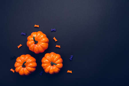 Halloween holiday background with pumpkins and bats. Flat lay, top view. Copy space for your text.の写真素材