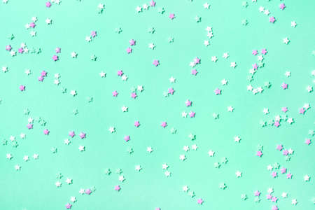 Little stars confetti on mint background. Holiday concept.の写真素材
