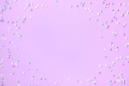Little stars confetti on lilac background. Holiday concept. Copy space for your text.の写真素材
