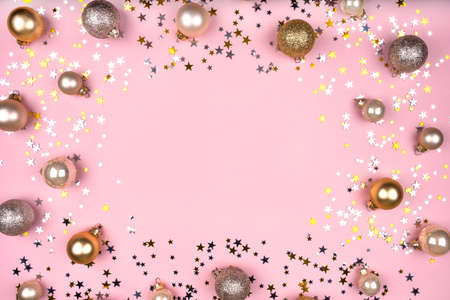 Festive pink background with gold and silver stars and Christmas balls. Flat lay, top view. Copy space for your text.の写真素材