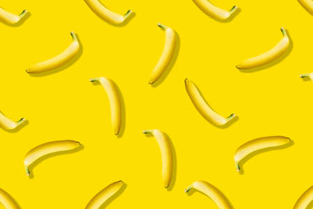 Pattern of ripe bananas on a yellow background. Flat lay.の写真素材