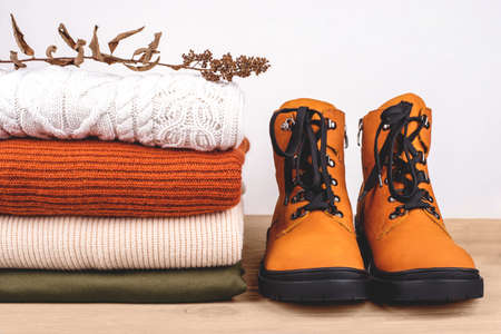 Pile of warm clothes on the table. Spring-Summer 2020 Colors.