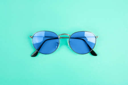 Blue sun-glasses on mint background. Color of year 2020.の写真素材