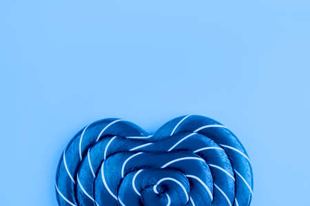 Lollipop on blue background. Trendy color of year.の写真素材