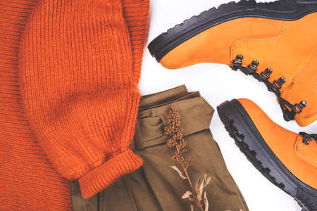 Warm clothes and boots on the table. Spring-Summer 2020 Colors. Flat lay.