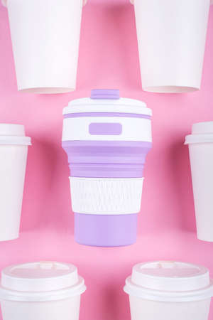 Reusable coffee cup vs disposable cups. Pink background. Zero waste concept.の写真素材