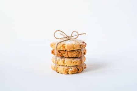 Stack of fresh cookies on white wooden table. Close up.