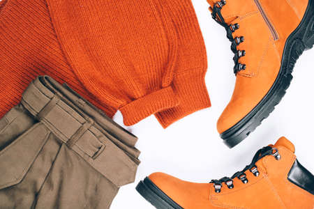 Warm clothes and boots on the tableの写真素材
