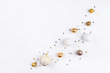 Festive white background with gold Christmas decorations.の写真素材