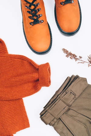 Warm clothes and boots on the table.の写真素材