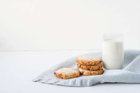 Stacked cookies on a linen napkin and a glass of milk. Close up.の写真素材