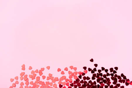 Pink background with red hearts. Valentines day concept. Top view. Copy space for text.の写真素材