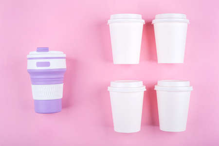 Reusable coffee cup vs disposable cups. Pink background. Zero waste concept.の写真素材