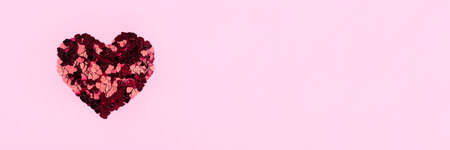 Heart of small red hearts on a pink background. Valentines day concept. Flat lay, top view.の写真素材