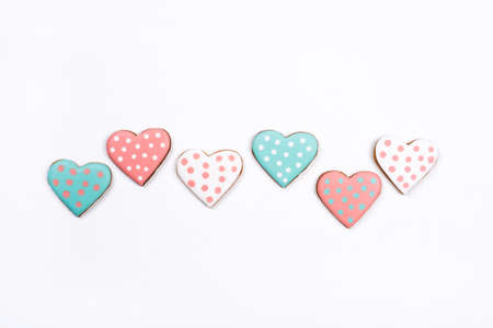 Gingerbread cookies with frosting in the shape of a heart on white background. Valentines day...
