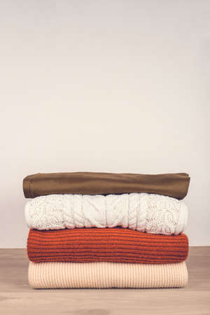 Pile of warm clothes on the table. Spring-Summer 2020 Colors. Copy space for text.の写真素材