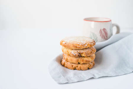 Stacked cookies on a linen napkin and a cup of coffee. Close up.の写真素材