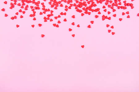 Pink background with red hearts. Valentines day concept. Top view. Copy space for text.の写真素材