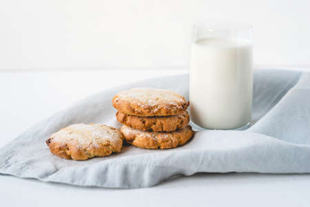 Stacked cookies on a linen napkin and a glass of milk. Close up.の写真素材