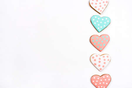 Gingerbread cookies with frosting in the shape of a heart on white background. Valentines day...