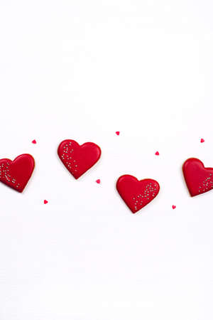 Gingerbread cookies with frosting in the shape of a heart. Valentines day concept. Flat lay, top view.の写真素材