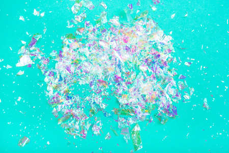 Pearl confetti on mint background. Flat lay, top view.の写真素材