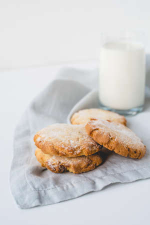 Stacked cookies on a linen napkin and a glass of milk. Close up.の写真素材