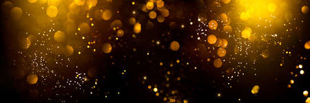 Golden abstract bokeh on black background. Holiday conceptの写真素材