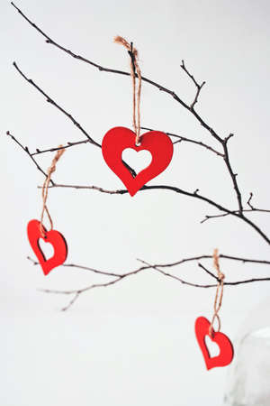 Decoration for Valentines Day with ornaments in the form of hearts on a branch.の写真素材