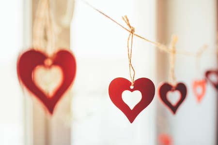 Decoration for Valentines Day with ornaments in the form of hearts on a branch.の写真素材
