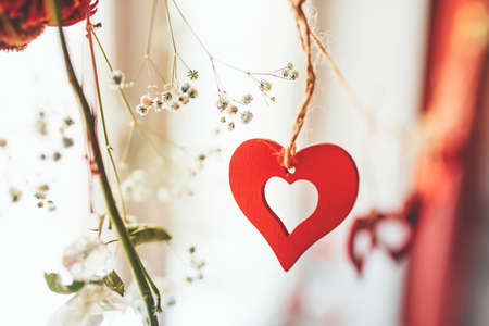 Decoration for Valentine's Day with ornaments in the form of hearts on a branch.の写真素材