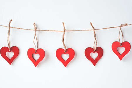 Valentines day decoration with ornaments in the form of hearts. White wooden background.の写真素材