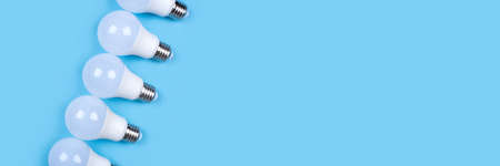 Several LED bulb on blue background. Saving energy concept. Ftat lay, top view, copy space.の写真素材