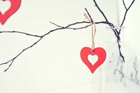 Decoration for Valentine's Day with ornaments in the form of hearts on a branch.の写真素材