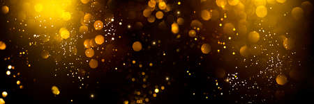Golden abstract bokeh on black background. Holiday conceptの写真素材