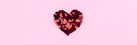 Heart of small red hearts on a pink background. Valentines day concept. Flat lay, top view.の写真素材