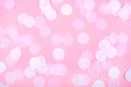 White confetti on pink background. Flat lay, top view.の写真素材