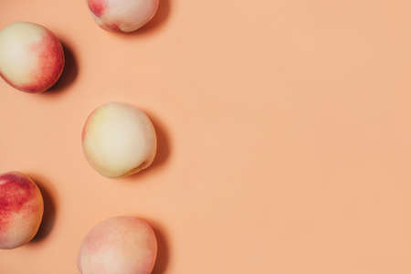 A few peaches on a pastel background. Flat lay, top view. Copy space for your text.の写真素材